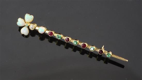 An early 20th century gold, white opal, diamond emerald and ruby bar brooch, 2.5in.